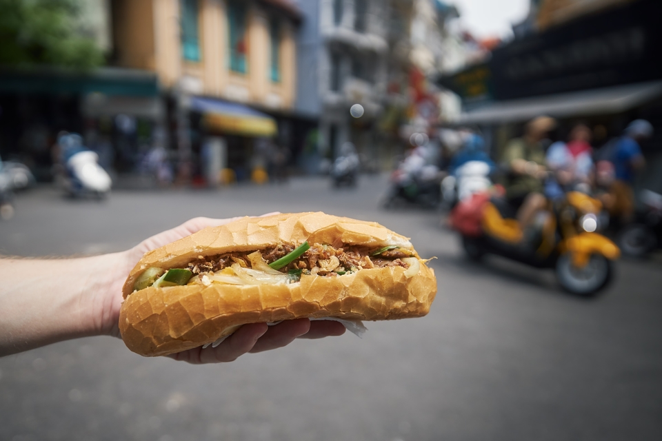 Banh mi met gemarineerd vlees, opgelegde groenten en verse kruiden
