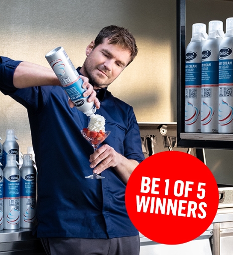 A man using Debic Spraycan while surrounded by hundreds of Spraycans on shelves.
