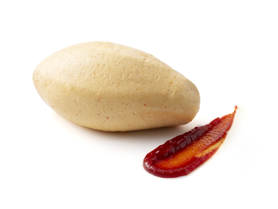 A smooth quenelle with a swipe of red fruit purée