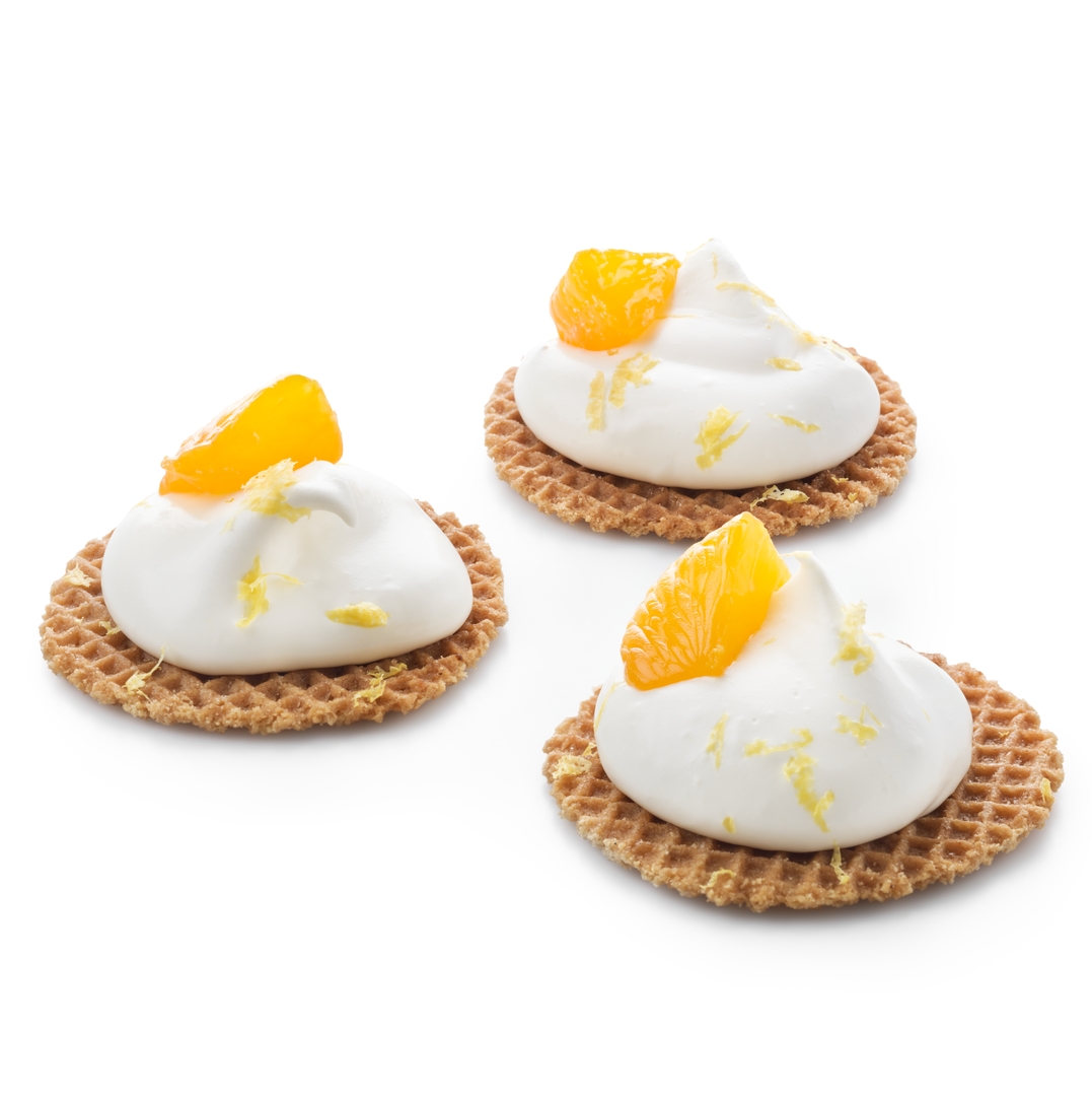 Mini stroopwafels garnis de crème fouettée et de morceaux de mandarine