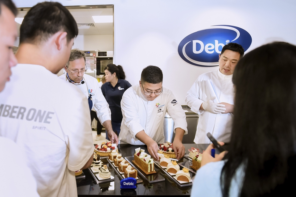 Chefs arranging pastries during a Debic bakery workshop