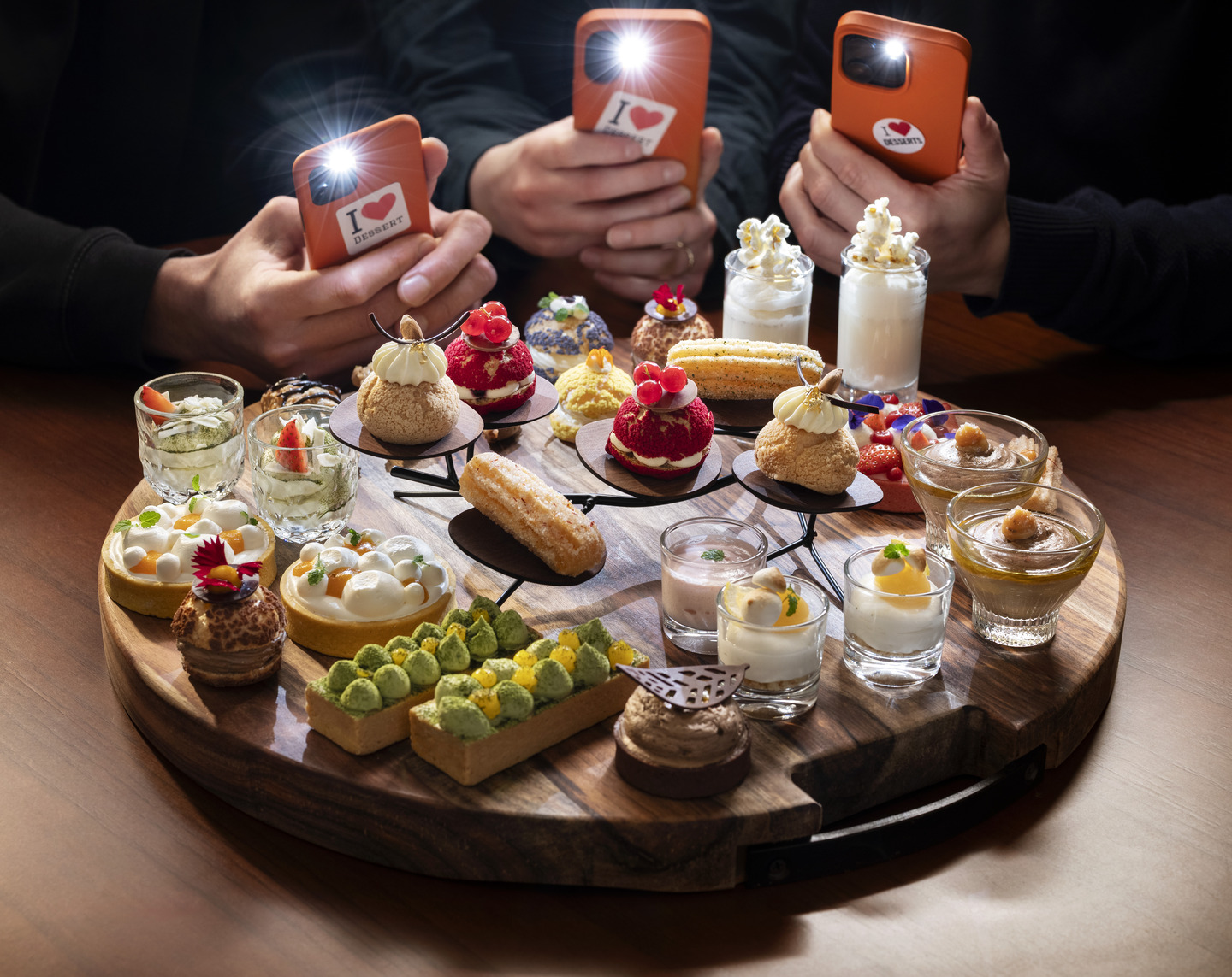 Plated tapas desserts with phone cameras pointed at them