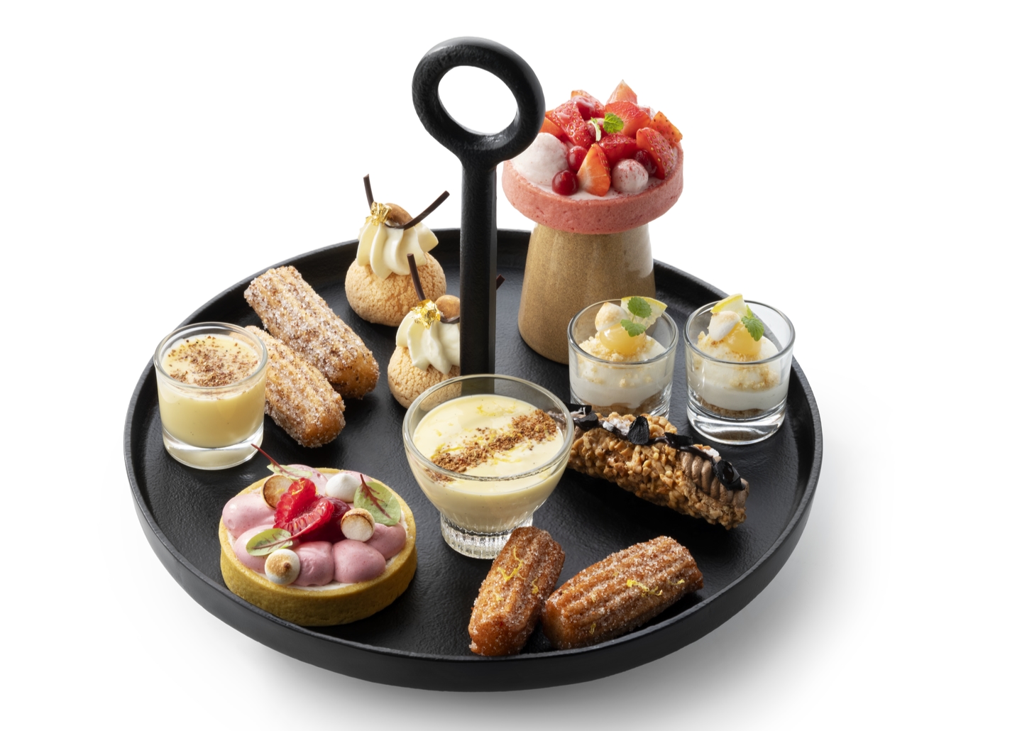 Assortiment mini‑desserten geserveerd op een zwart etagèrebord.
