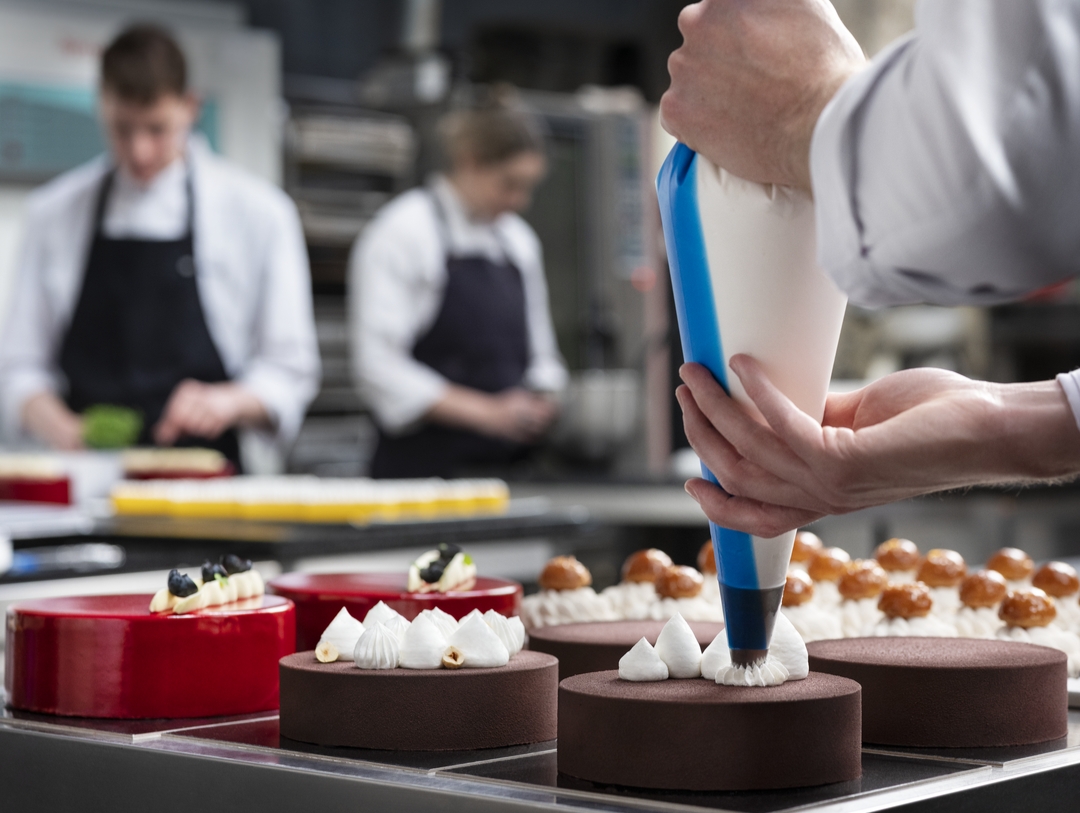 Bakers decorating pastry with Debic Mixes products
