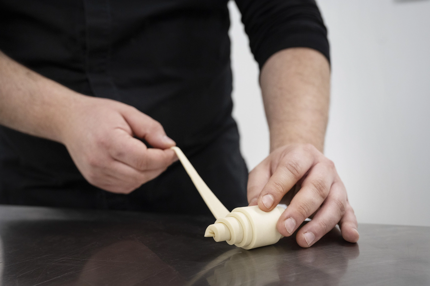 Chef folding croissant