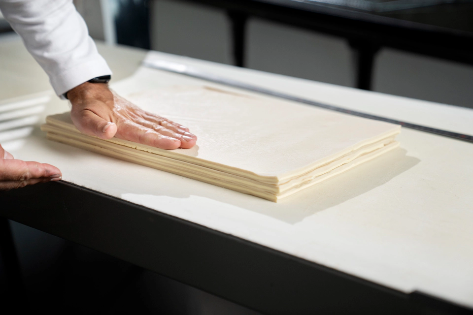 Chef measuring dough layers