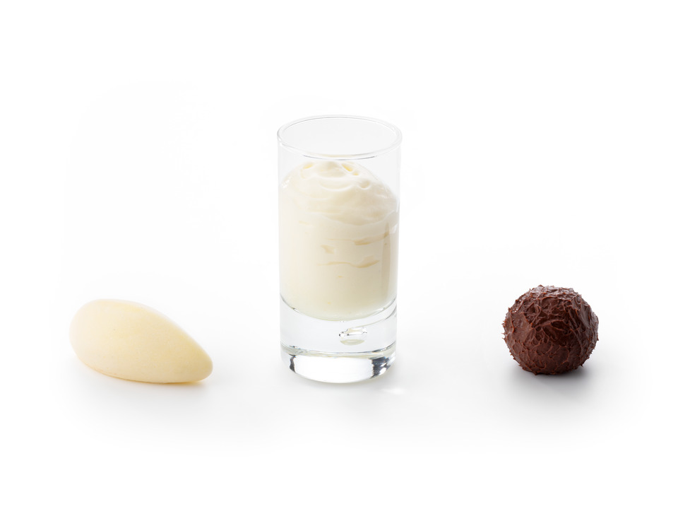 Three applications of Debic Crème Anglaise Bourbon on a white background: a quenelle of vanilla ice cream, airy sabayon served in a glass, and a chocolate ganache truffle.