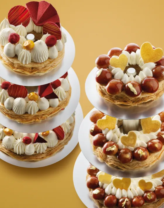 Stacked decorated pastry rings on a gold background